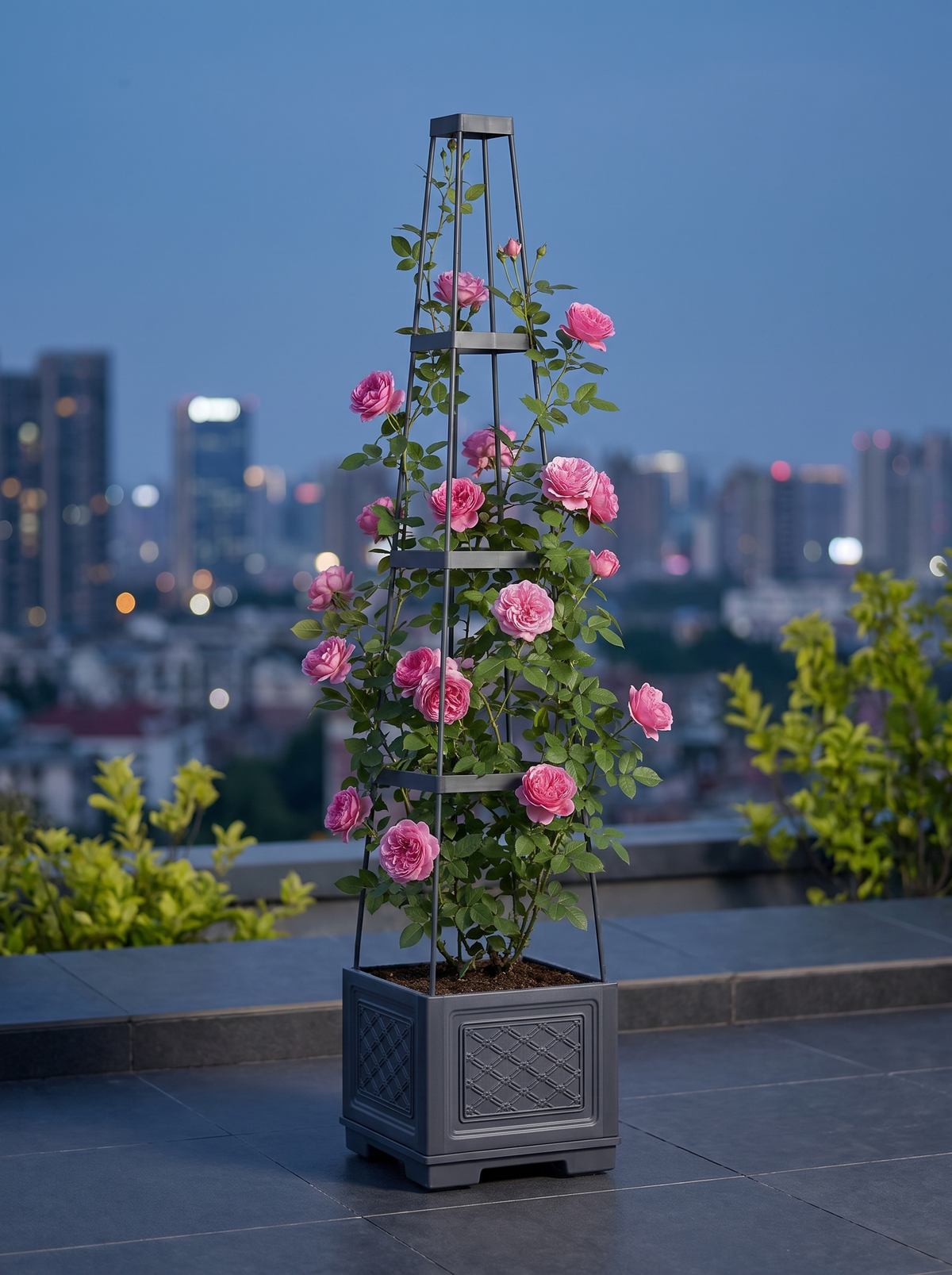 Grey self-watering planter and trellis on an urban terrace; plants shown for styling