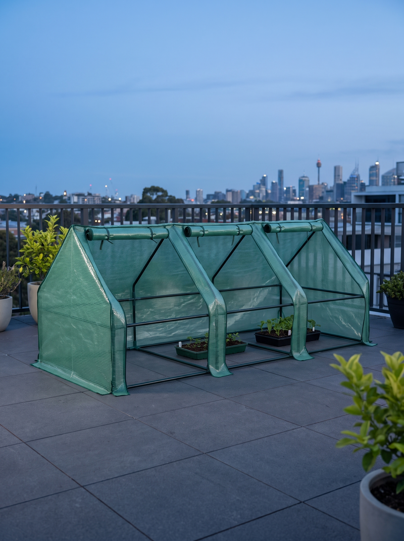 Mini Greenhouse — 2.4 × 0.9m in an outdoor setting; scene props and plants shown for styling